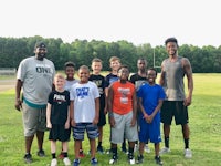 a group of boys posing for a picture on a field